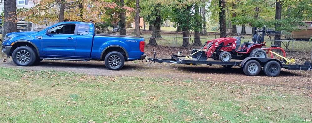 Tractor loaded on trailer for haul